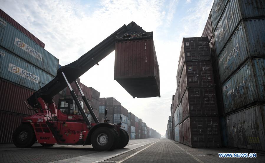 A crane handles a container at the Qinzhou Port in south China