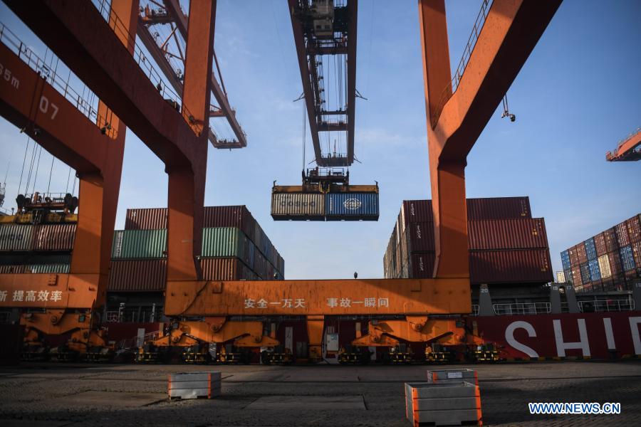 Photo taken on Dec. 28, 2020 shows containers being handled at the Qinzhou Port in south China