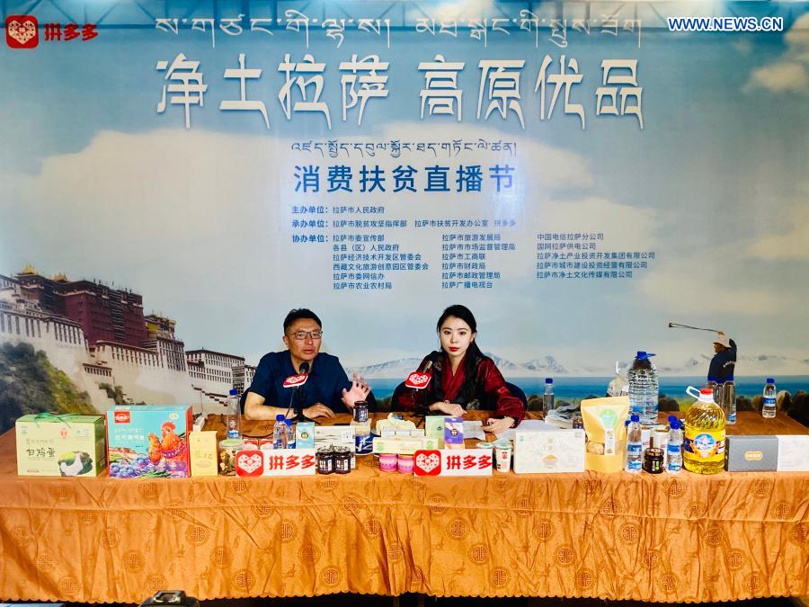 Qime Cering (L), chief of Damxung County, livestreams to promote local products on an e-commerce platform in Lhasa, southwest China
