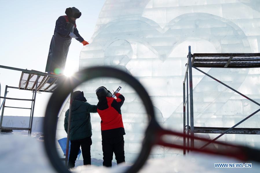 Sun Hongyan (R) works in the venue of Harbin Ice and Snow World in northeast China