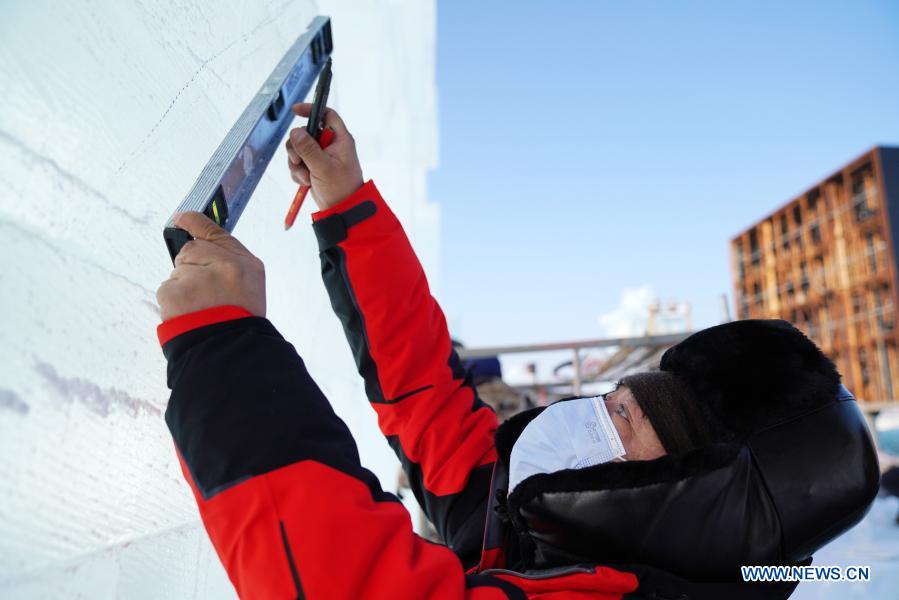 Sun Hongyan works in the venue of Harbin Ice and Snow World in northeast China