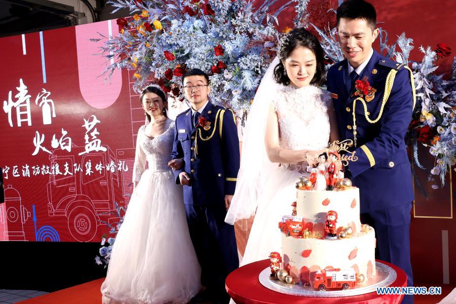 Firefighters and their wives attend a group wedding ceremony in east China