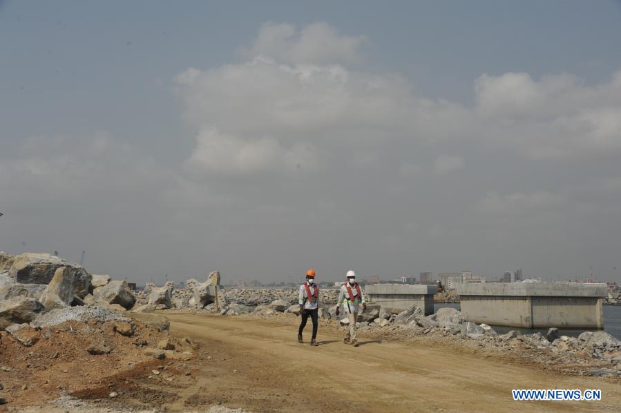 Ghanaian workers walk at the construction site of Tema Liquefied Natural Gas (LNG) Import Terminal Project in Tema, Ghana, on Jan. 5, 2021. Ghana