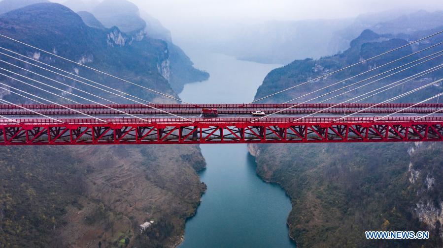 Aerial photo shows workers sprinkling salt to clear ice off the road on Yachi River Bridge in southwest China