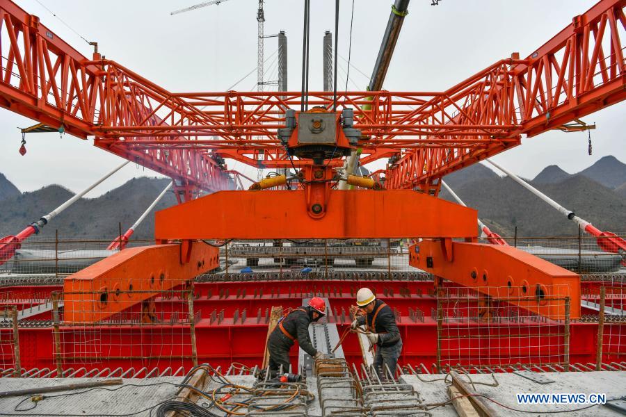 People work at the construction site of the 1,720-meter-long Yunwu Bridge of the Duyun-Anshun expressway in Guiding County, southwest China