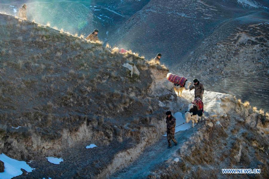 Team members lead the yaks slowly down the mountain during a border patrol in northwest China
