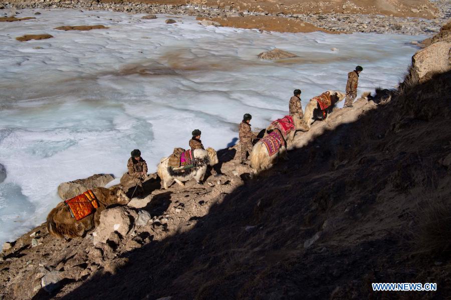 Team members go on a border patrol with yaks in northwest China