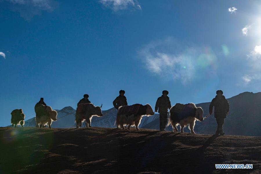 Team members go on a border patrol with yaks in northwest China