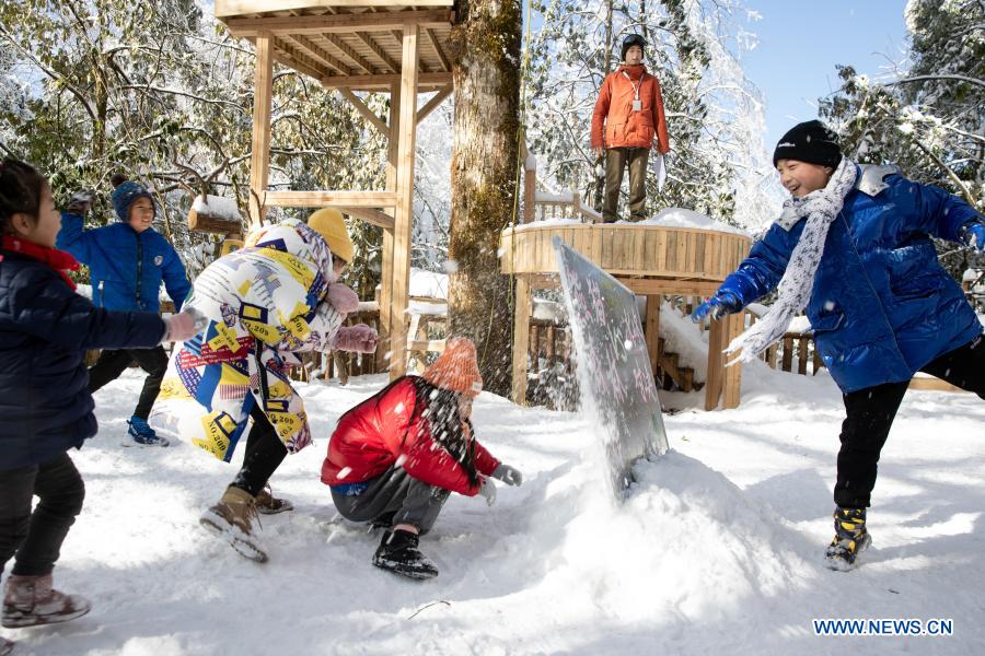 Students from Huchangbao Primary School have snow fight at a camp in Longcanggou National Forest Park in Yingjing County, southwest China