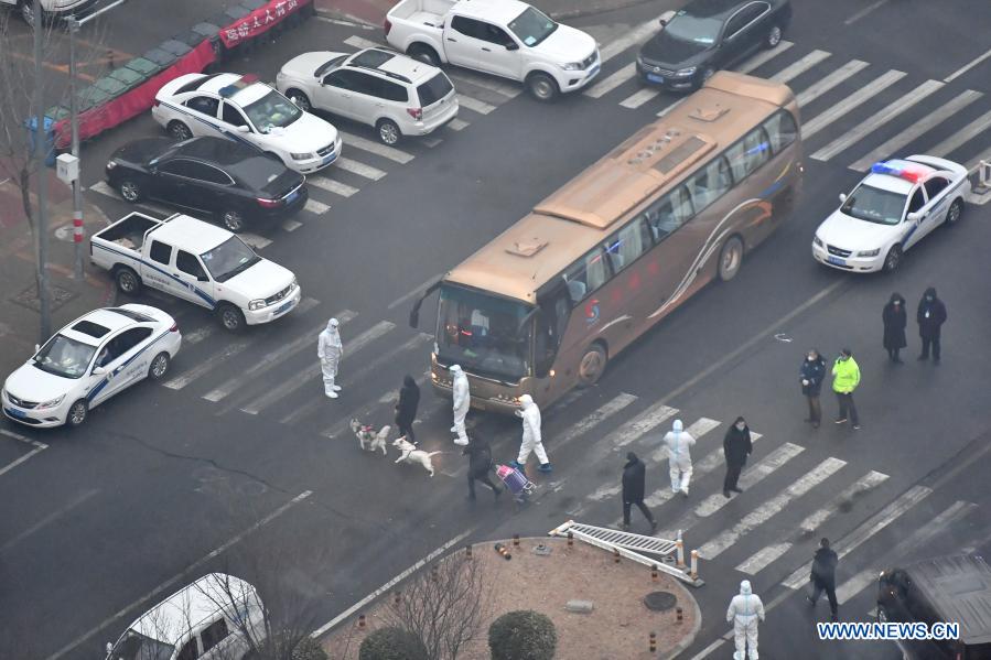 Residents are about to go to the COVID-19 quarantine center with their dogs in the Ronghui residential compound in Daxing