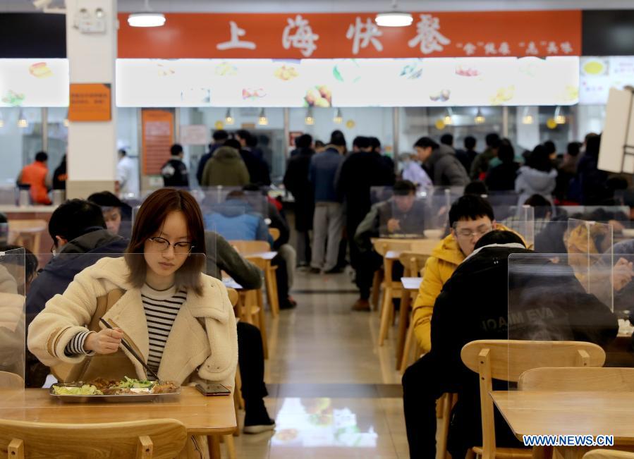 Teachers and students have meals at a canteen in the Shanghai Jiao Tong University, east China
