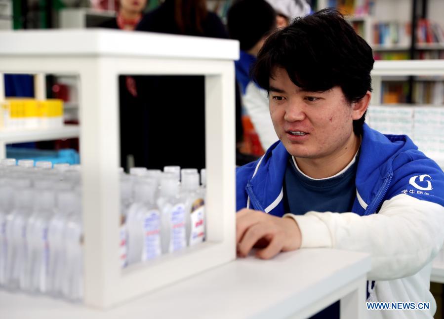 Wu Zhihao, a undergraduate student from Xinjiang Uygur Autonomous Region in northwest China, works at the student service center in the Shanghai Jiao Tong University, east China