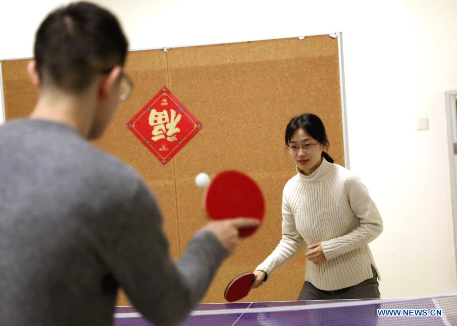Zhao Linchuan (R), a doctoral candidate from Liaoning in northeast China, plays table tennis with her classmates in the Shanghai Jiao Tong University, east China