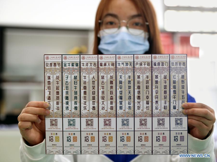 A staff member displays meal coupons for students who stay on campus for the Chinese Lunar New Year at the Shanghai Jiao Tong University, east China