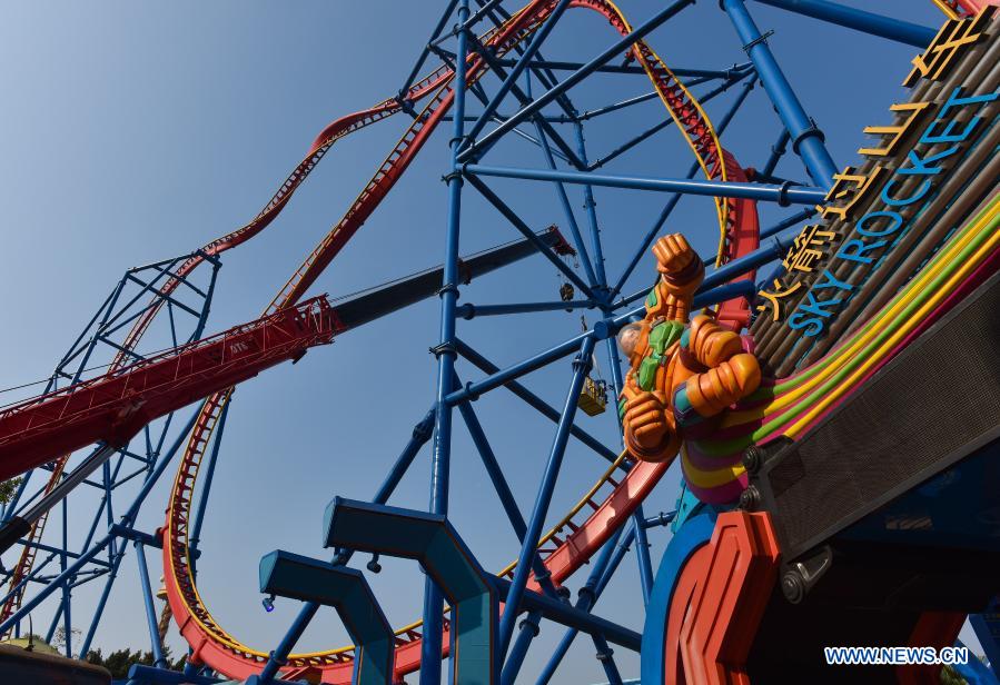 Maintenance workers carry out annual safety inspection on a roller coaster at Chimelong Tourist Resort in the run-up to the Lunar New Year holiday in Guangzhou, south China