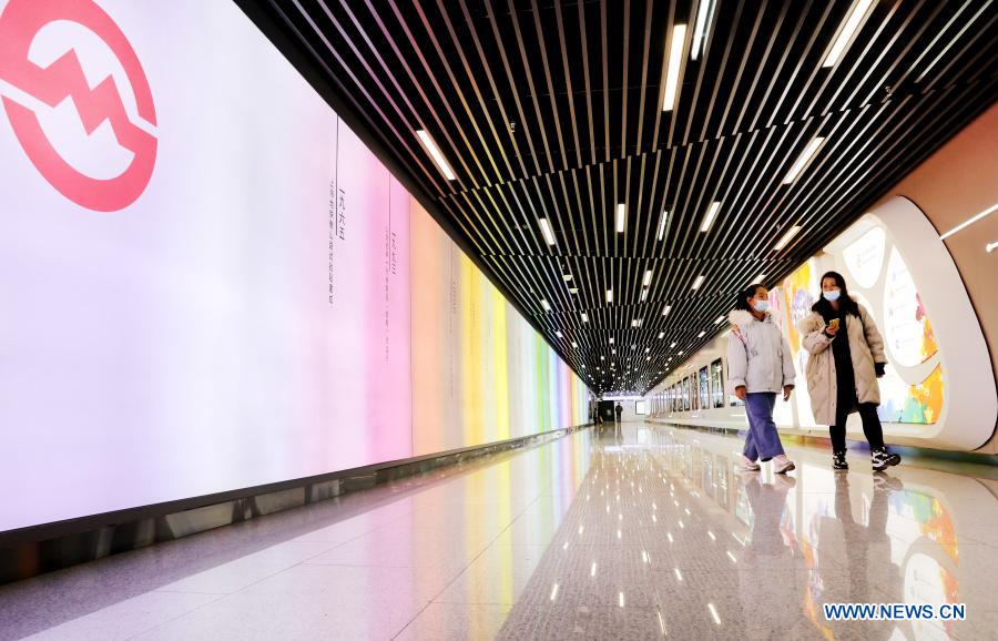 Passengers walk in a corridor of Wuzhong Road Station of Shanghai Subway Line 15 in Shanghai, east China, Feb. 9, 2021. The Shanghai Subway Line 15 started trial operation on Jan. 23. (Xinhua/Fang Zhe)