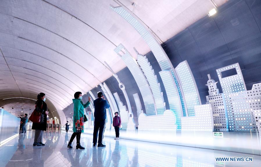 People take photos at Wuzhong Road Station of Shanghai Subway Line 15 in Shanghai, east China, Feb. 9, 2021. The Shanghai Subway Line 15 started trial operation on Jan. 23. (Xinhua/Fang Zhe)