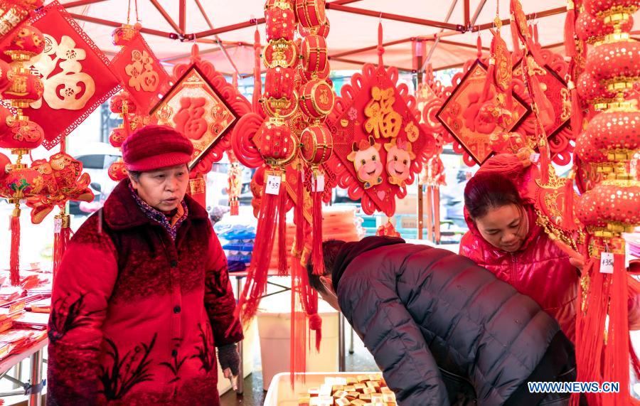 Customers purchase decorations for the upcoming Chinese Lunar New Year in Taohong Town of Longhui County in Shaoyang City, central China