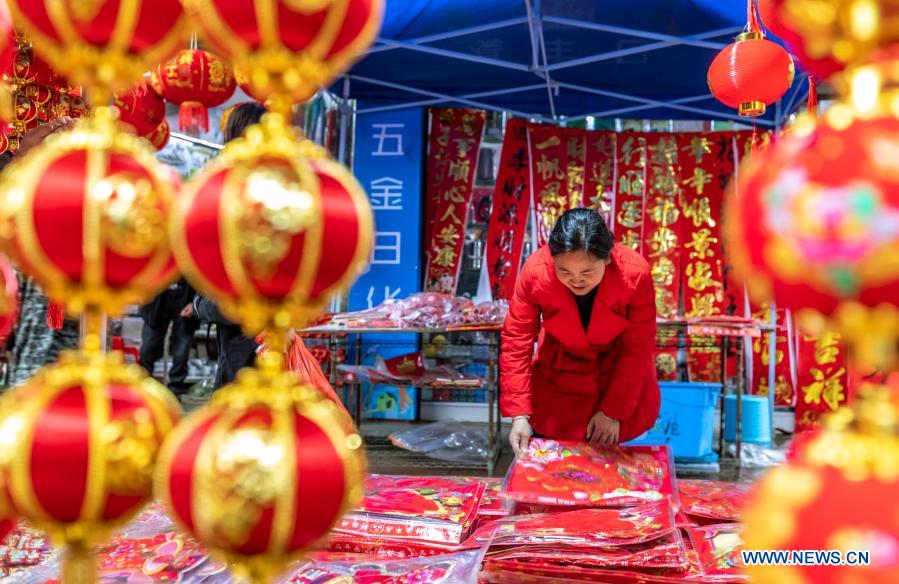 A customer purchases decorations for the upcoming Chinese Lunar New Year in Taohong Town of Longhui County in Shaoyang City, central China
