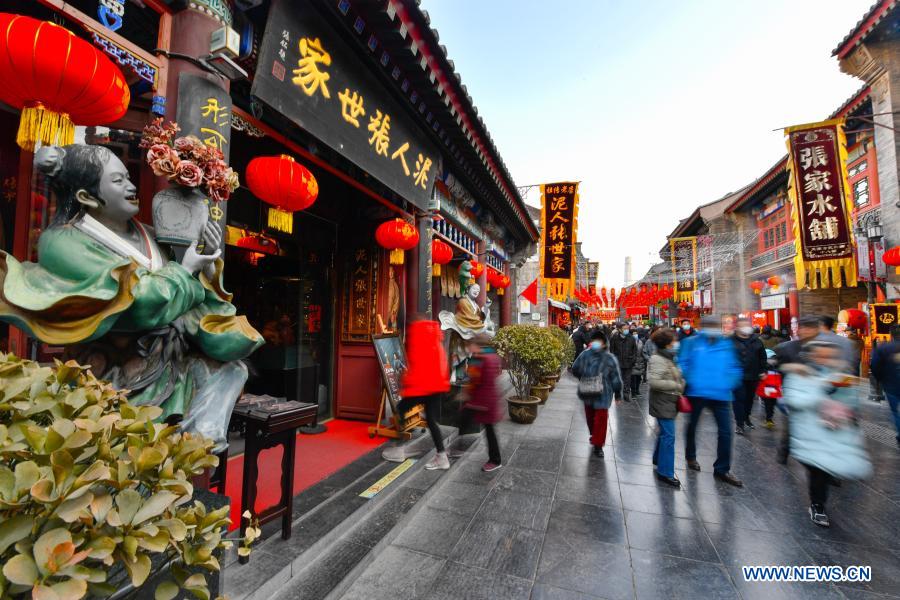 People visit an ancient cultural street in Tianjin, north China, Feb. 17, 2021, the last day of this year