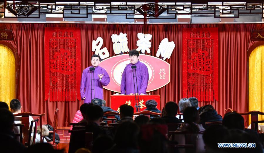 Chinese Xiangsheng or crosstalk artists perform at a teahouse on an ancient cultural street in Tianjin, north China, Feb. 17, 2021, the last day of this year