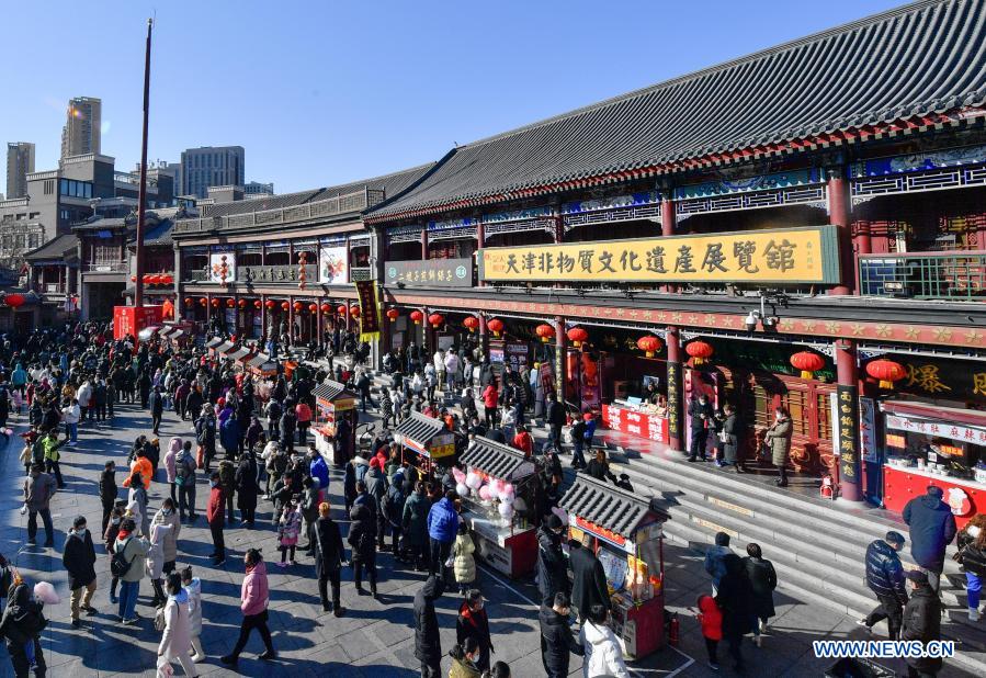 People visit an ancient cultural street in Tianjin, north China, Feb. 17, 2021, the last day of this year