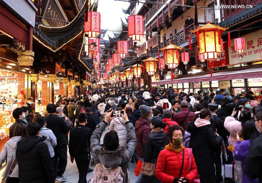 Tourists visit the Yuyuan Garden scenic area in east China