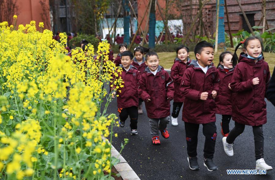 Students run in the campus on their first day of the new semester at a primary school in southwest China