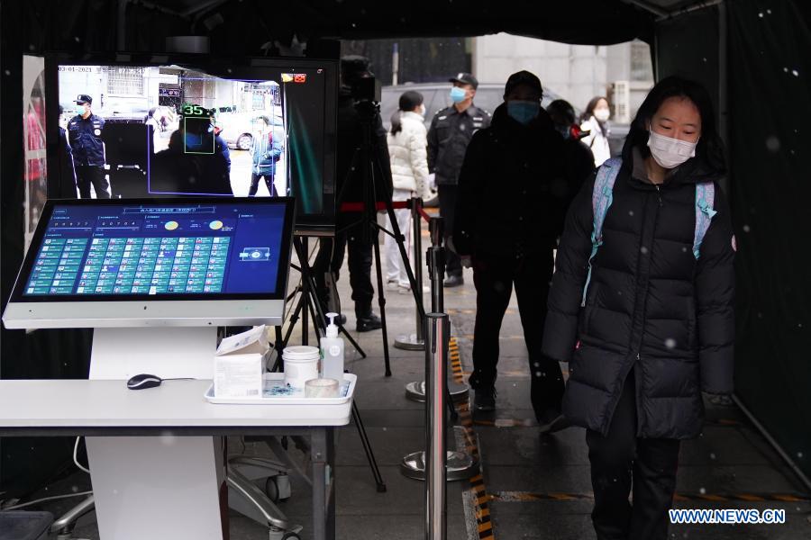 Students get their body temperature automatically checked before entering the Experimental High School Attached to Beijing Normal University in Beijing, capital of China, March 1, 2021. Middle school and primary school students returned to school as scheduled for the spring semester in Beijing on Monday amid coordinated epidemic control efforts. (Xinhua/Ju Huanzong) 