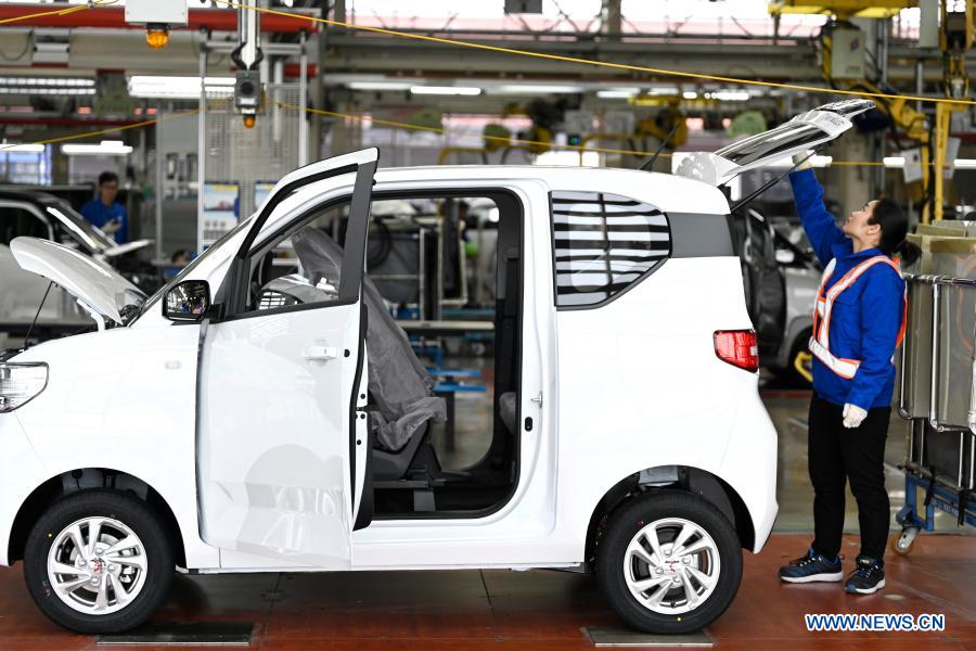 An employee works at a production line of new energy vehicles in Liuzhou, south China