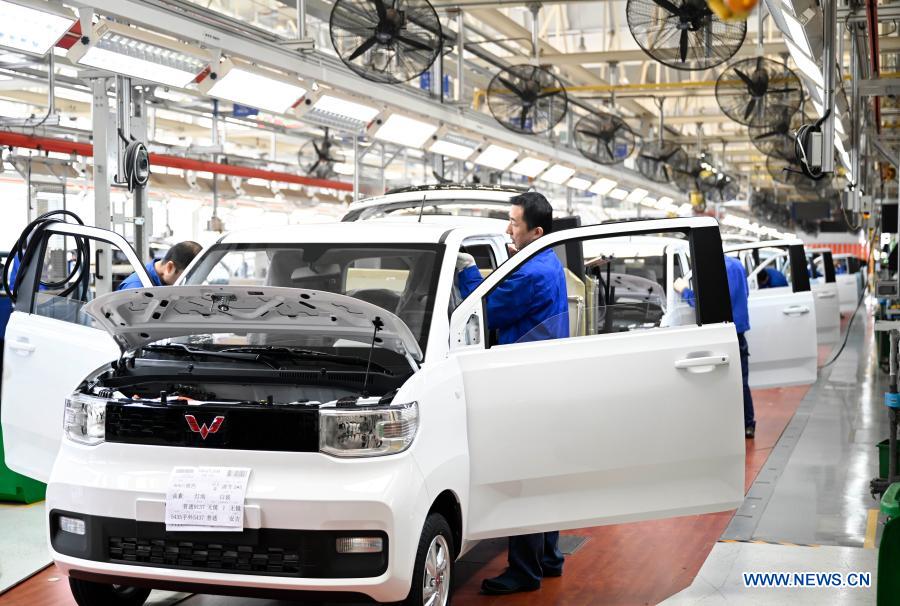 An employee works at a production line of new energy vehicles in Liuzhou, south China