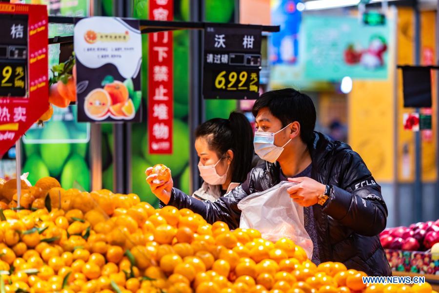 People select food at a supermarket in Xixiu District of Anshun, southwest China