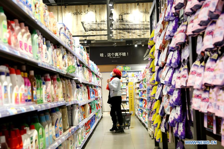 People select products at a supermarket in Lianyungang City, east China