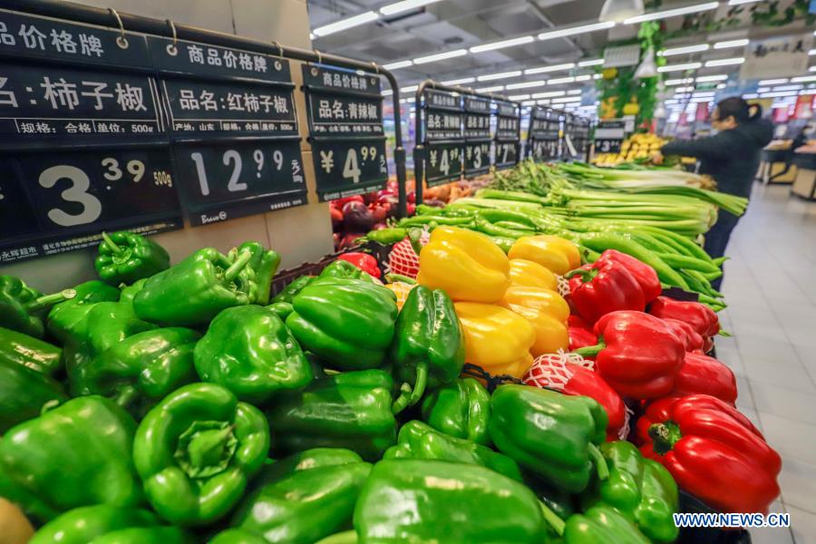 People select food at a supermarket in Zunhua City of Tangshan, north China