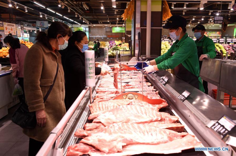 People select food at a supermarket in Xinle City of Shijiazhuang, north China