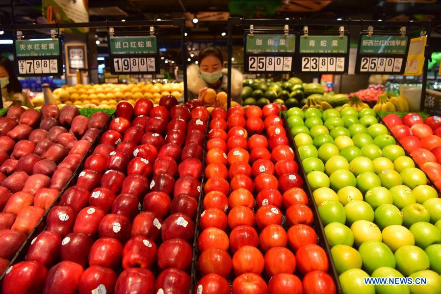 People select food at a supermarket in Danzhai County of Qiandongnan Miao and Dong Autonomous Prefecture, southwest China