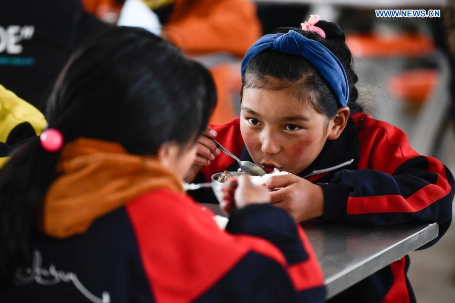 Students have lunch in a primary school in Gande County of Tibetan Autonomous Prefecture of Golog in northwest China