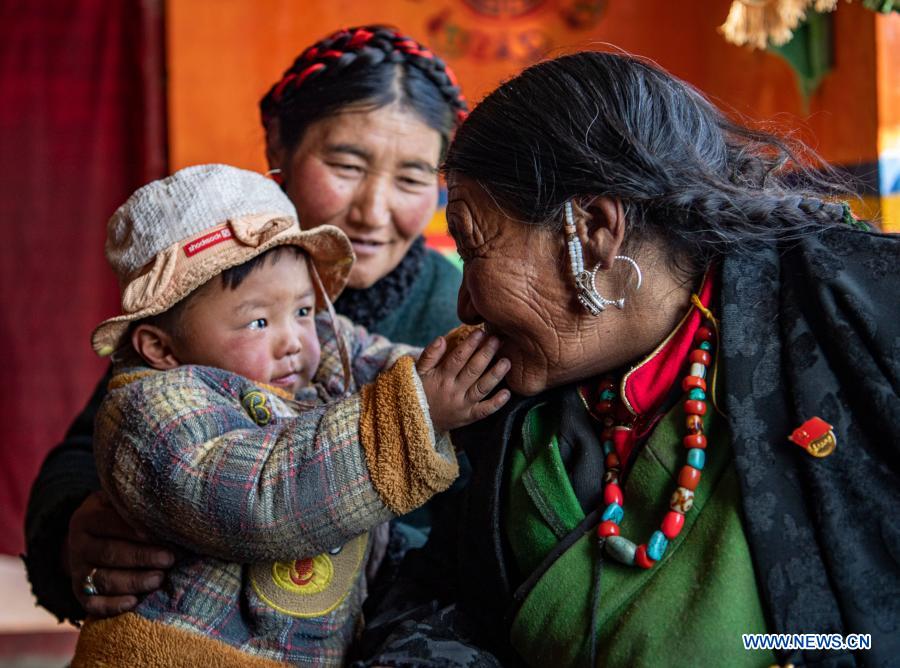 Tenzin Tsomo interacts with her granddaughter in southwest China