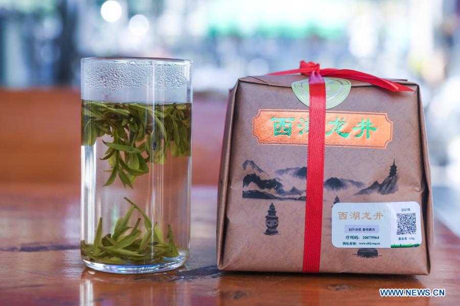 Photo taken on March 23, 2021 shows tea water and finished tea products in Hangzhou, east China