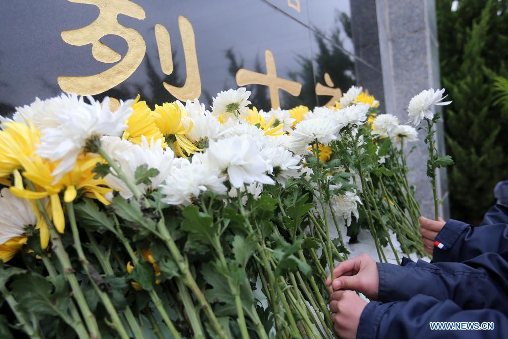 Students offer flowers at a cemetery for martyrs in Huaibei, east China