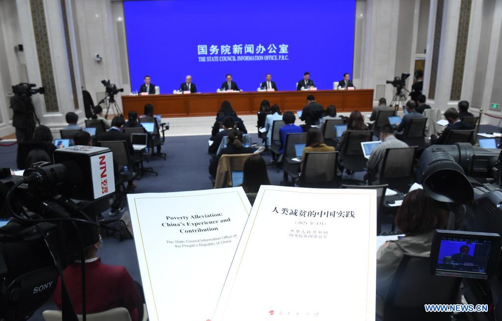 Photo taken on April 6, 2021 shows the Chinese and English editions of the white paper titled "Poverty Alleviation: China