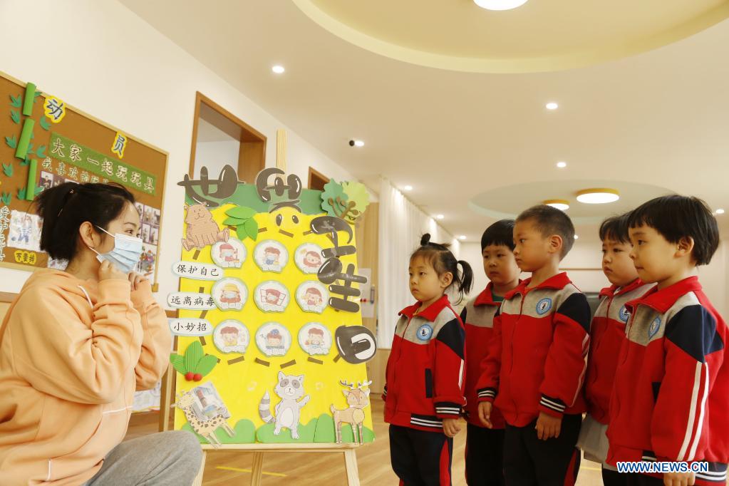 Children learn how to wear a mask correctly at a kindergarten on the occasion of World Health Day in Xingtai City, north China