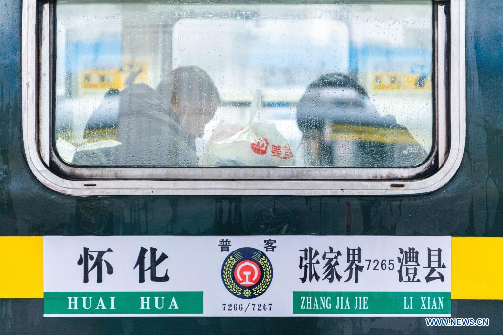 Passengers are seen on the train 7266 at Huaihua Station in central China